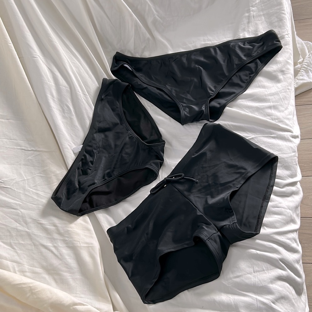 Swimsuit, bottoms, one boy short style, and two bikini bottoms. Black size L/XL.